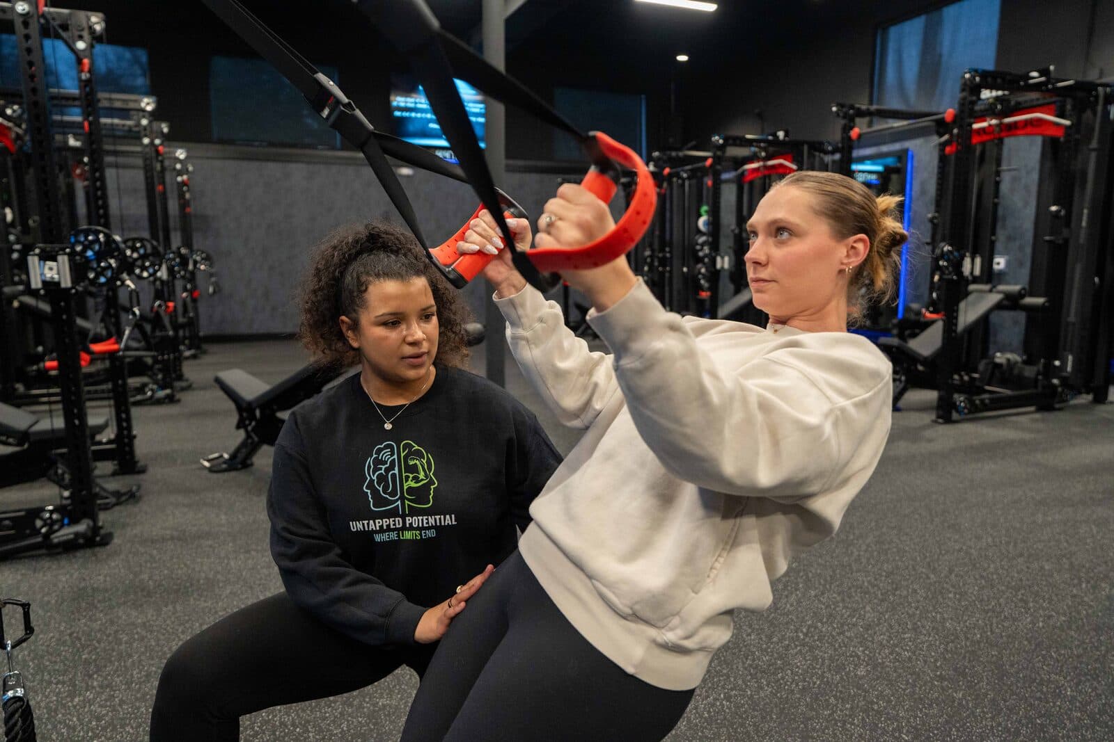 UPP trainer coaching a client on TRX suspension trainer